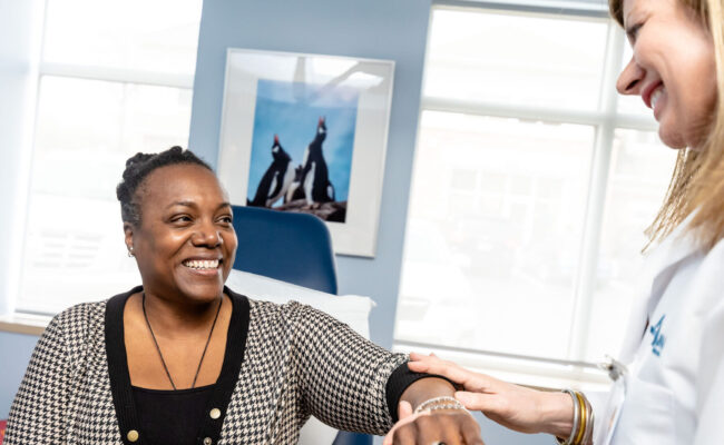 Apex Dermatologist giving patient annual skin exam.