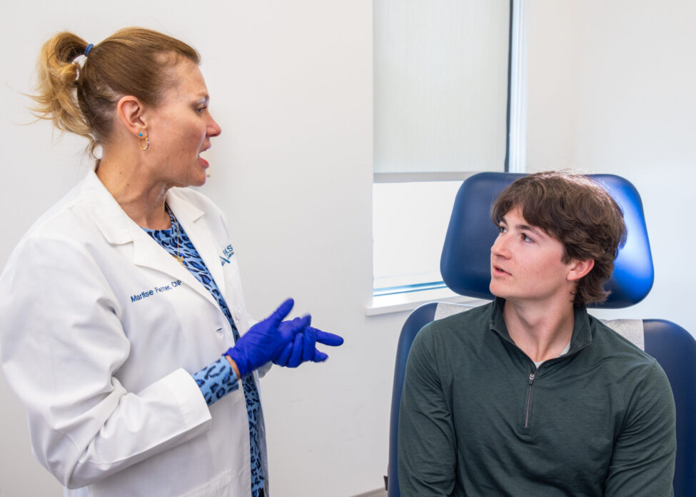 Dermatologist meets with teenage patient to address skin concerns